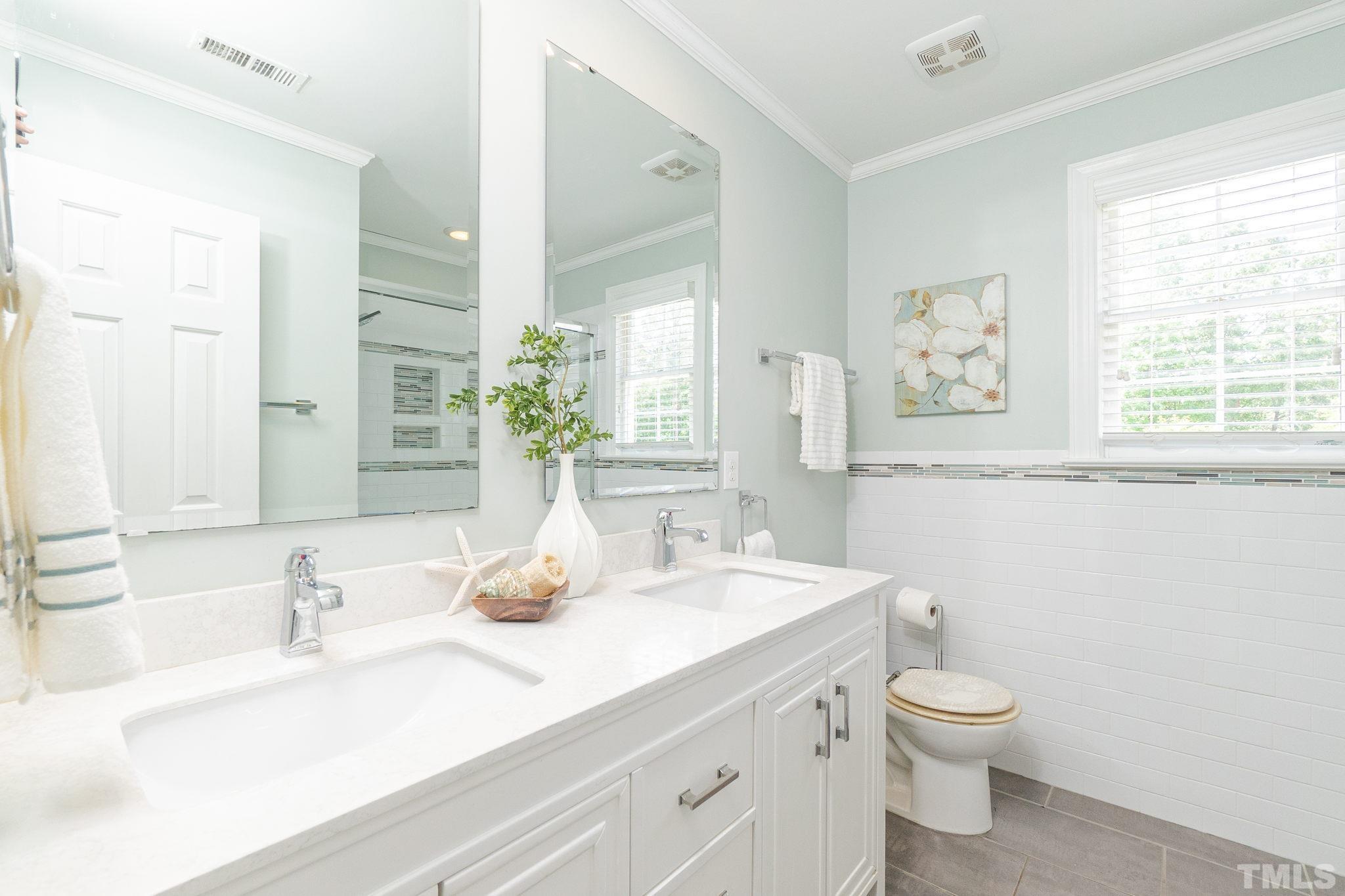 5717 Raddington Street Raleigh, NC 27613 - Photo 33 of 58 a bathroom with a granite countertop sink mirror and a
