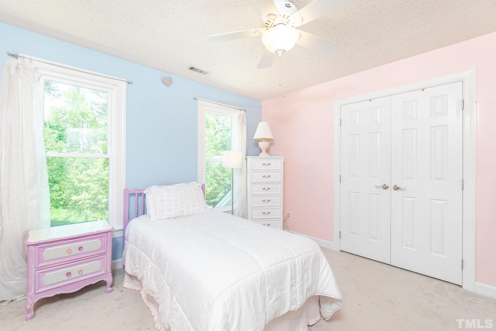 5717 Raddington Street Raleigh, NC 27613 - Photo 36 of 58 a bedroom with a bed and a window