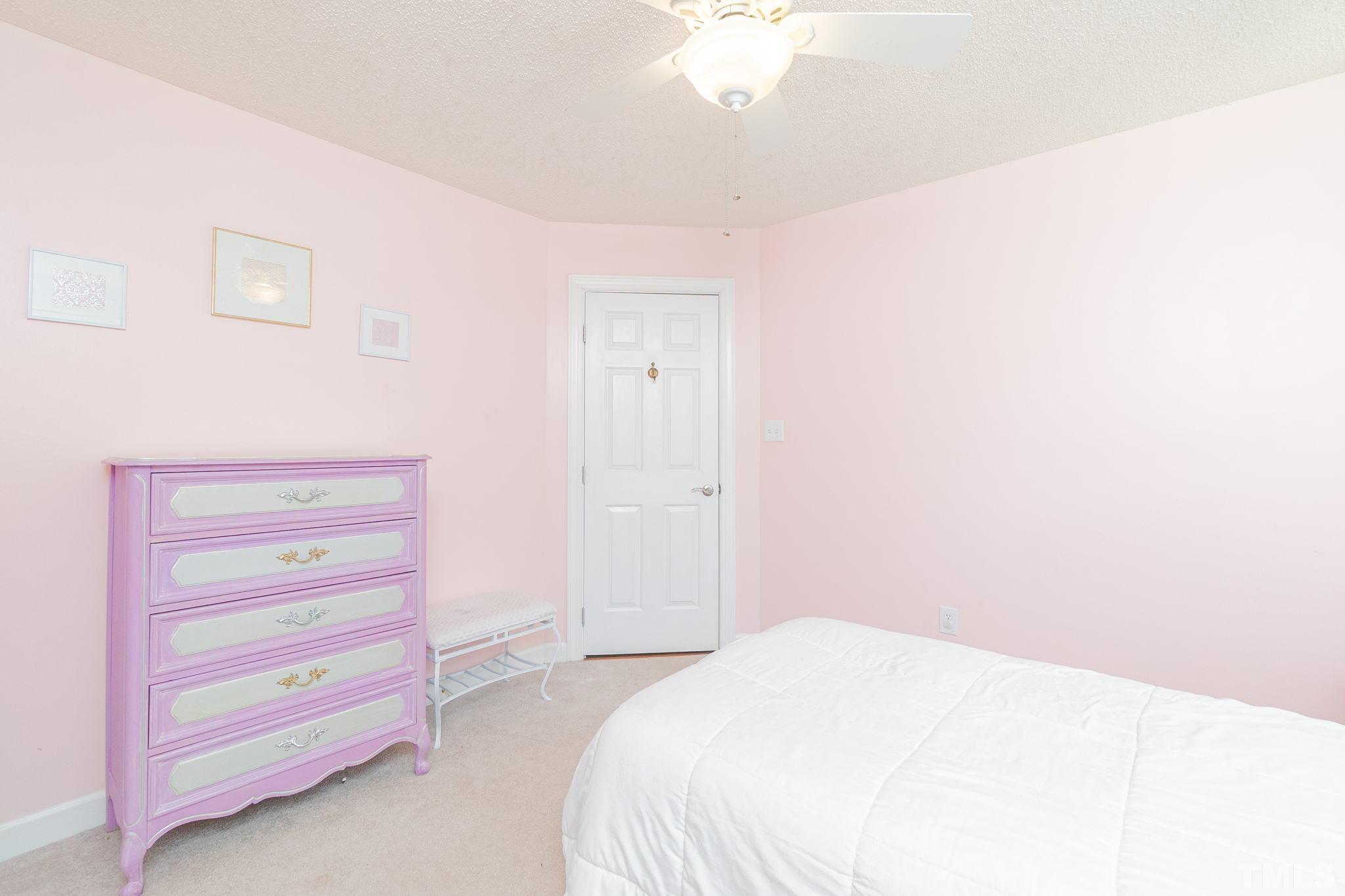 5717 Raddington Street Raleigh, NC 27613 - Photo 37 of 58 a bedroom with a bed and a dresser