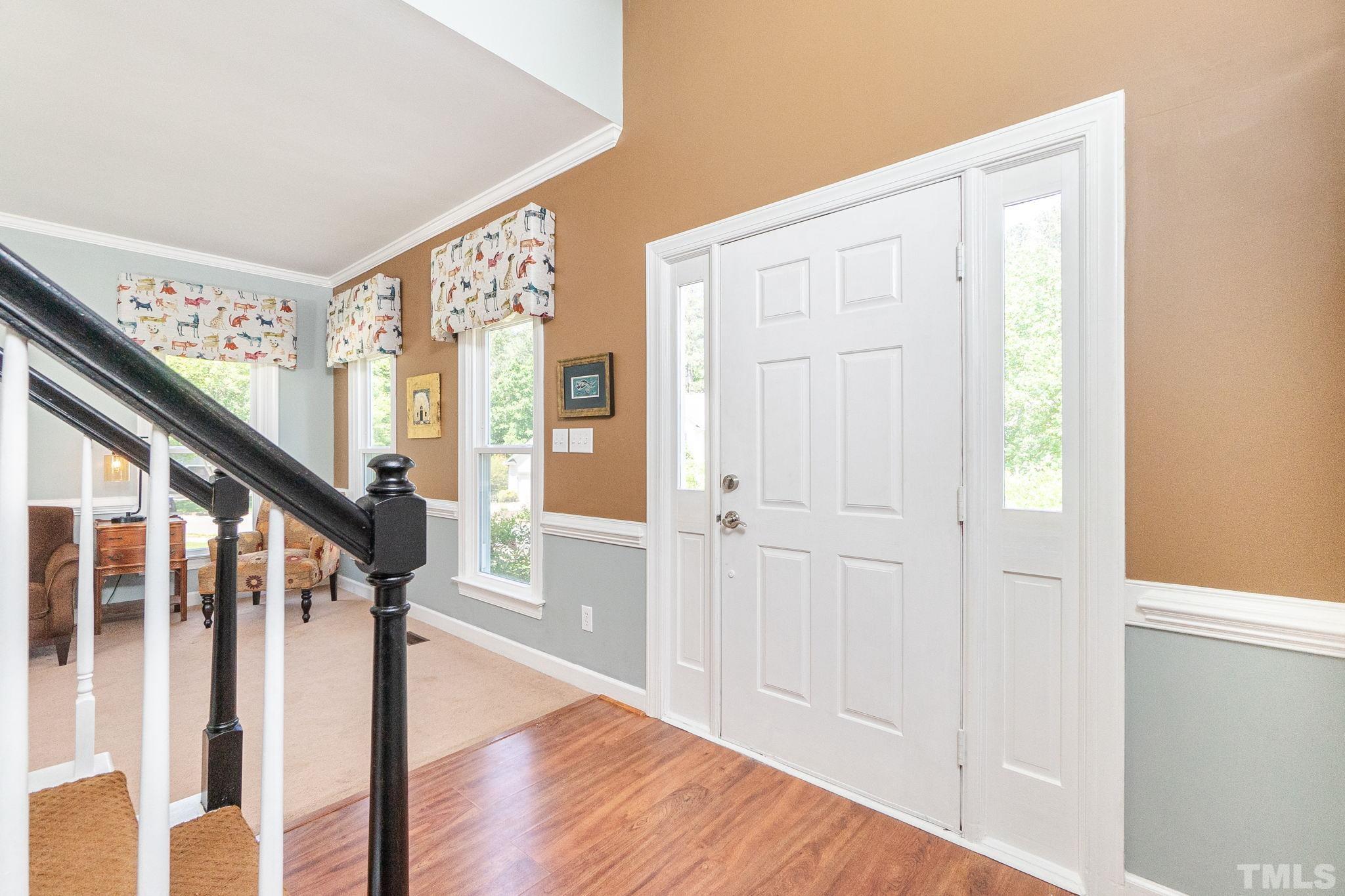 5717 Raddington Street Raleigh, NC 27613 - Photo 4 of 58 a view of an entryway with wooden floor