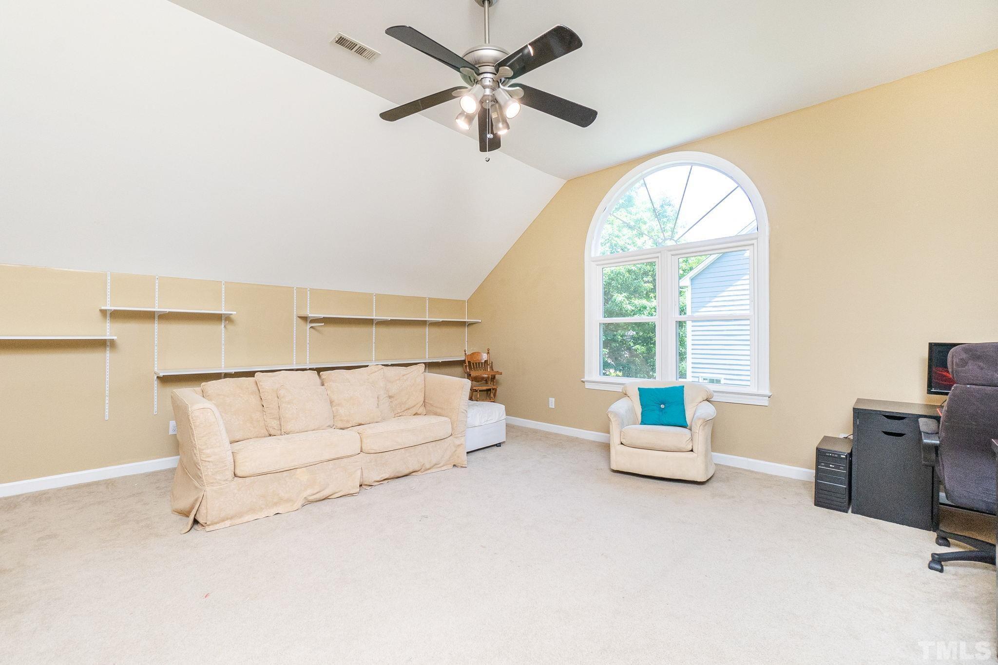 5717 Raddington Street Raleigh, NC 27613 - Photo 45 of 58 a living room with furniture and a large window