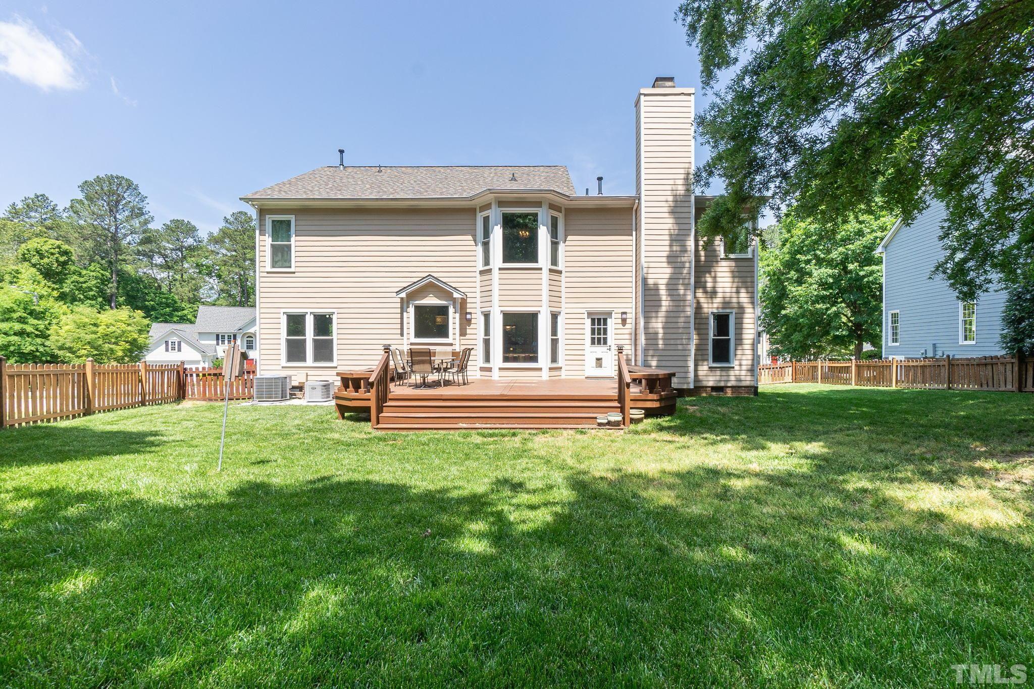 5717 Raddington Street Raleigh, NC 27613 - Photo 49 of 58 a view of a house with backyard porch and garden