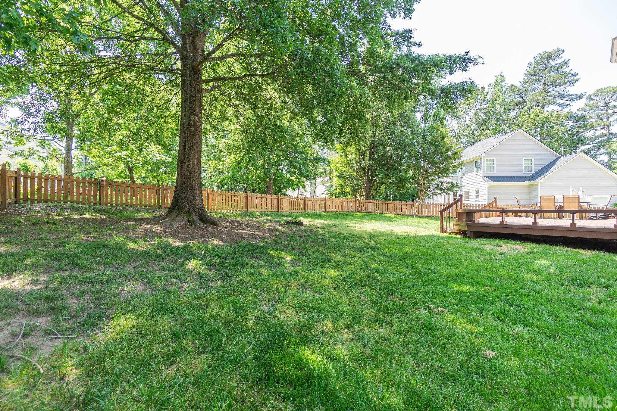 5717 Raddington Street Raleigh, NC 27613 - Photo 54 of 58 a view of a backyard with table and chairs and a small yard