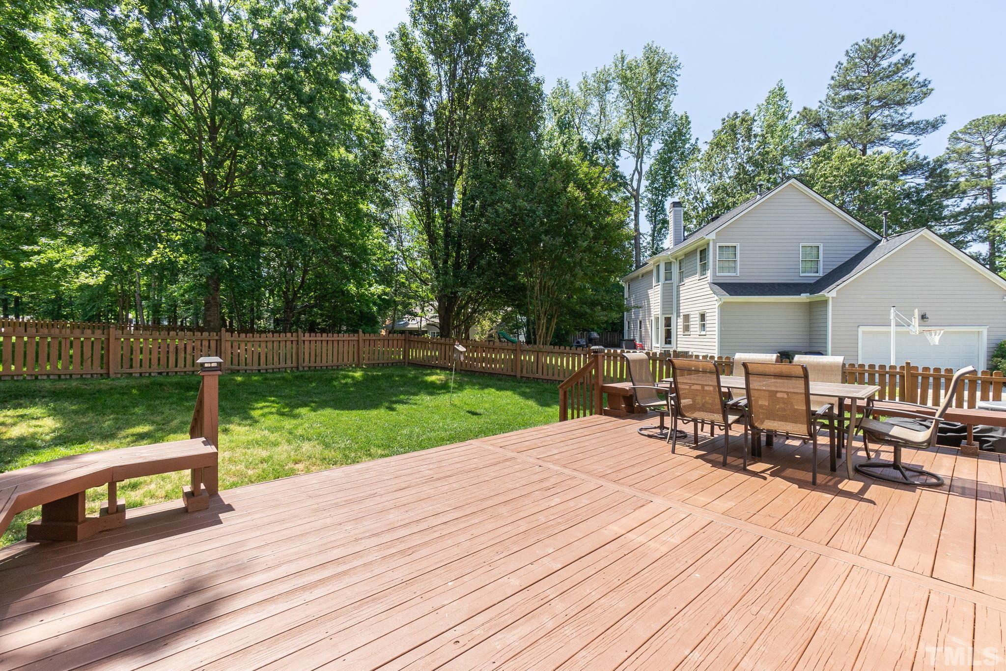 5717 Raddington Street Raleigh, NC 27613 - Photo 56 of 58 a view of a patio with table and chairs wooden floor and fence