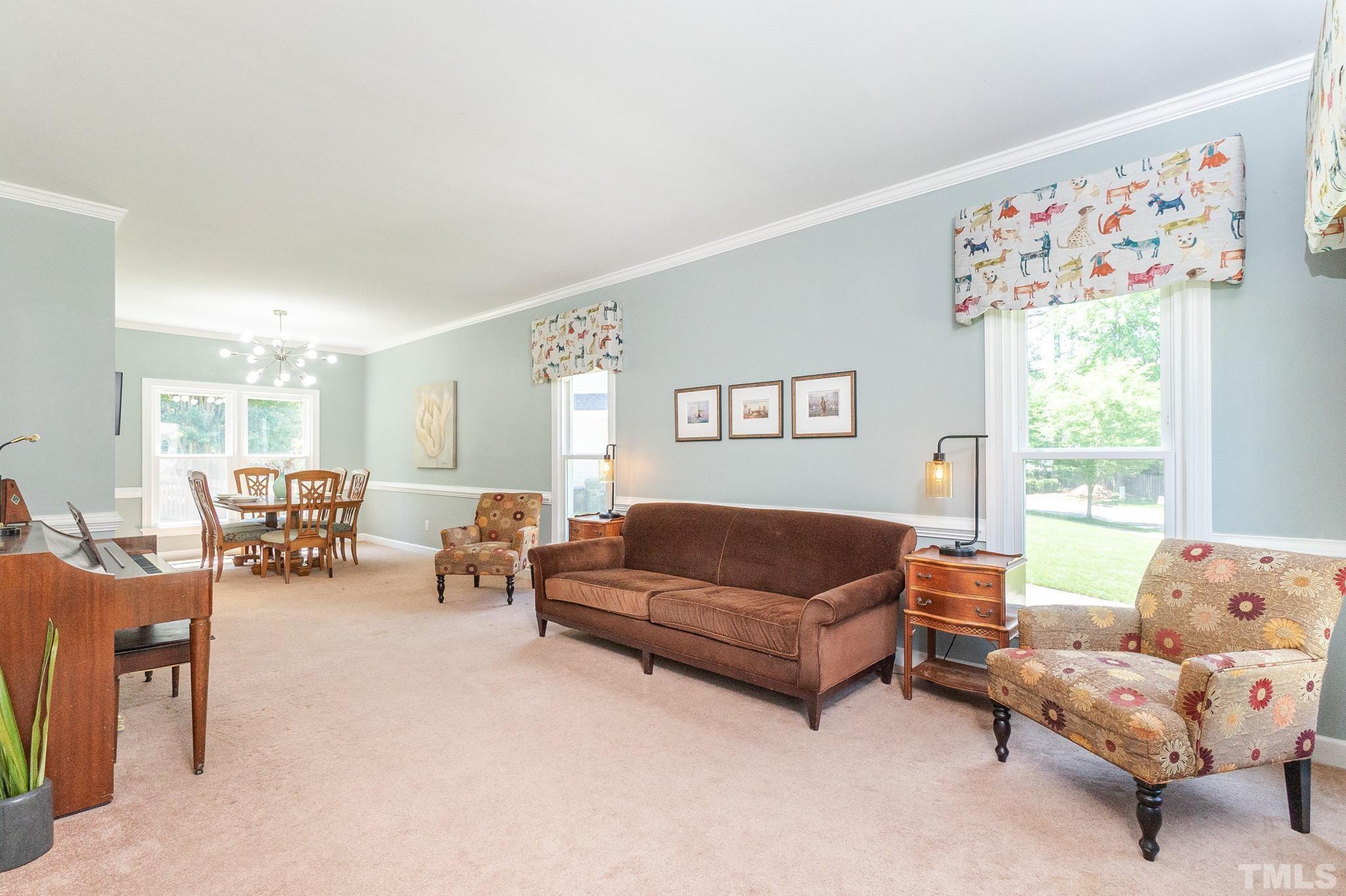 5717 Raddington Street Raleigh, NC 27613 - Photo 7 of 58 a living room with furniture and a large window