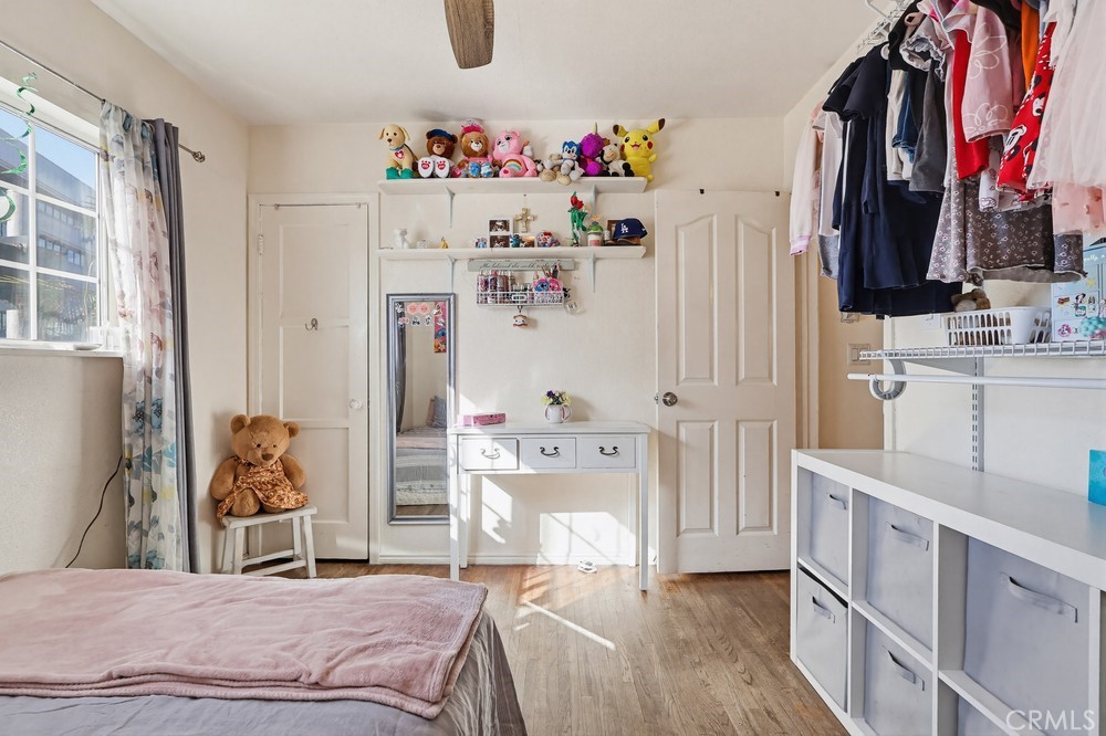 10970 Ruth Avenue Lynwood, CA 90262 - Photo 14 of 27 a bedroom with a bed and white cabinets