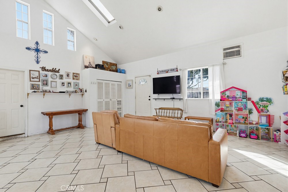 10970 Ruth Avenue Lynwood, CA 90262 - Photo 16 of 27 a living room with furniture and a flat screen tv