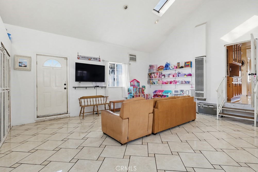 10970 Ruth Avenue Lynwood, CA 90262 - Photo 18 of 27 a living room with furniture and a flat screen tv
