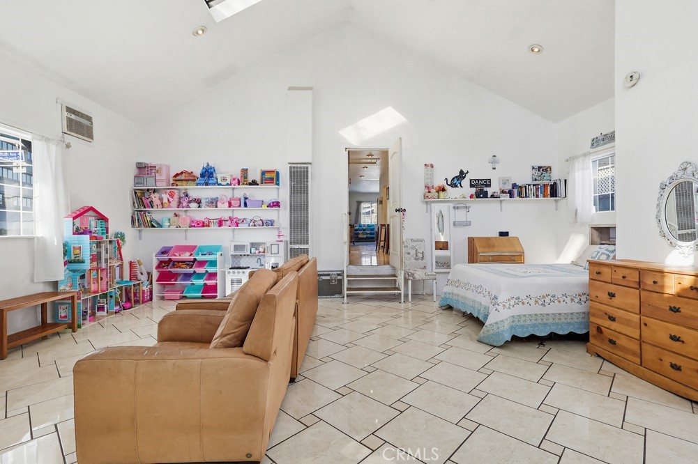 10970 Ruth Avenue Lynwood, CA 90262 - Photo 19 of 27 a living room with furniture and a baby crib