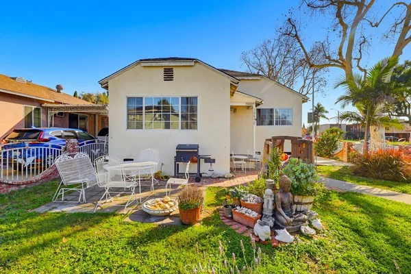 a front view of house with yard and outdoor seating