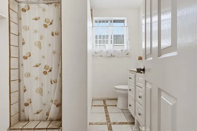 a bathroom with a toilet and a shower