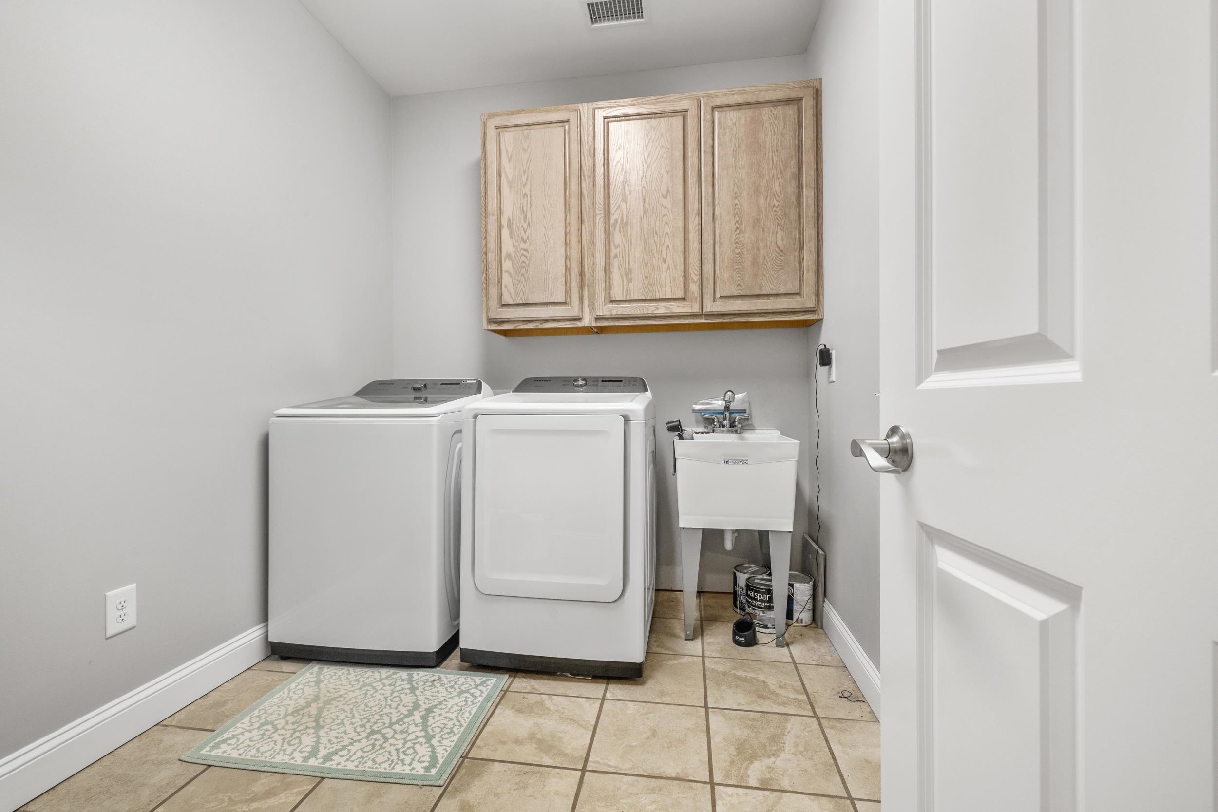 5907 Haskell Circle Myrtle Beach, SC 29577 - Photo 29 of 38 Laundry area with cabinet space, light tile patterned flooring, and independent washer and dryer