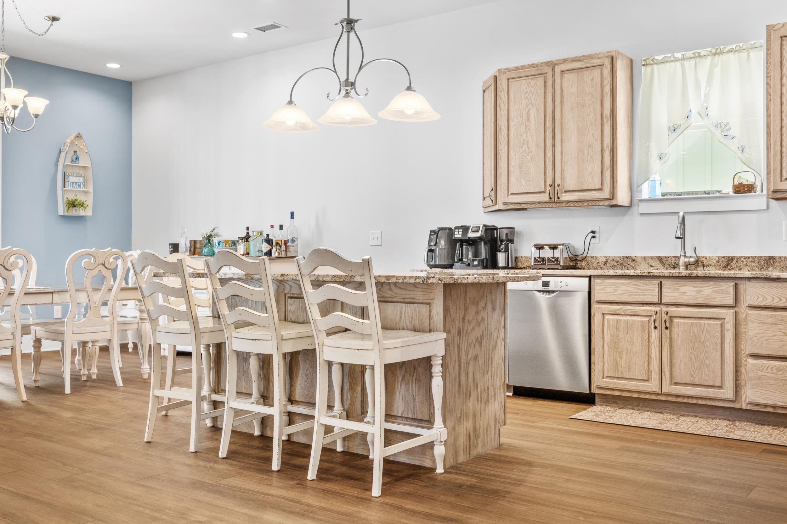 5907 Haskell Circle Myrtle Beach, SC 29577 - Photo 8 of 38 Kitchen featuring a breakfast bar, light brown cabinets, light wood-style floors, a chandelier, and recessed lighting