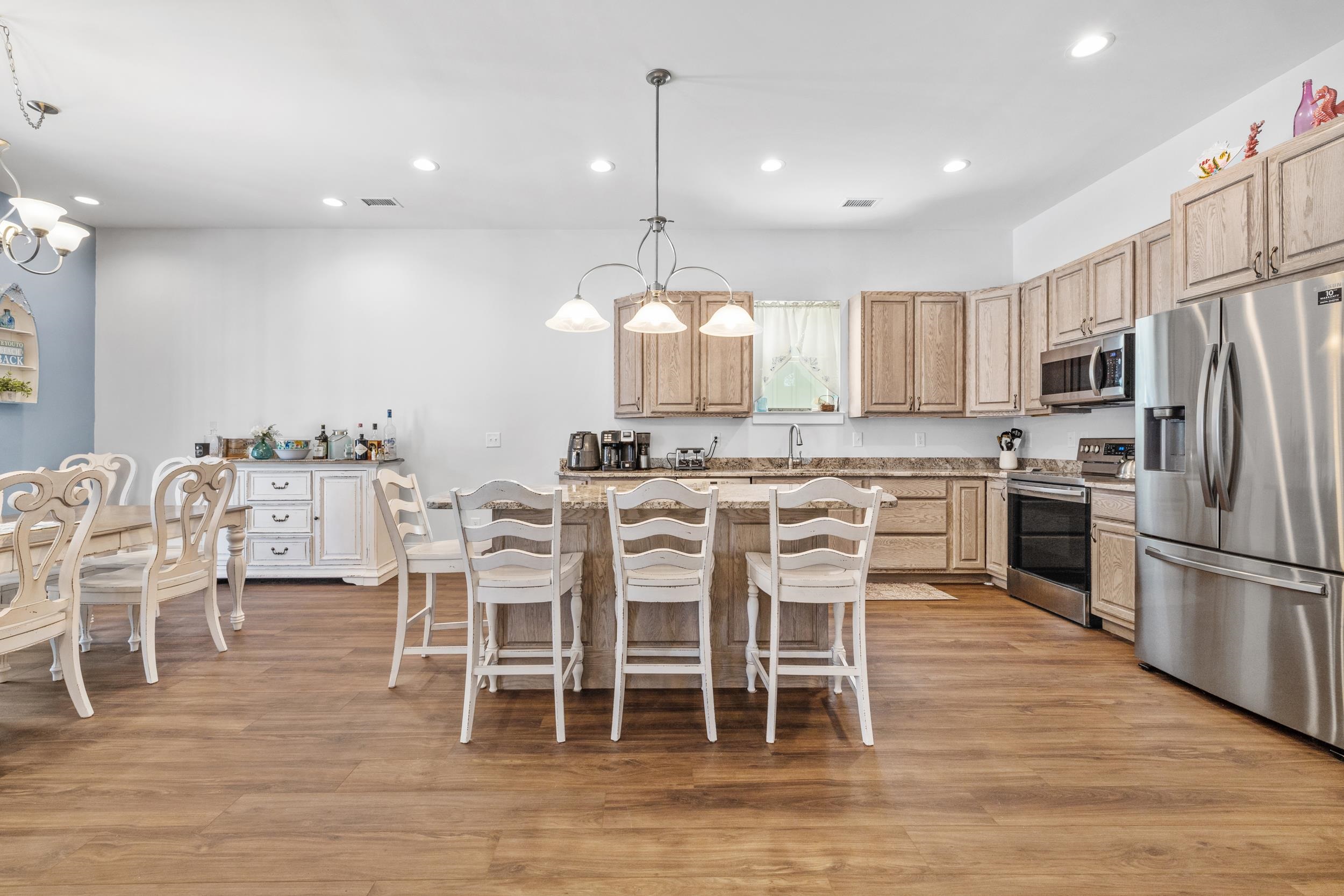 5907 Haskell Circle Myrtle Beach, SC 29577 - Photo 9 of 38 Kitchen with a chandelier, a breakfast bar area, appliances with stainless steel finishes, pendant lighting, and recessed lighting