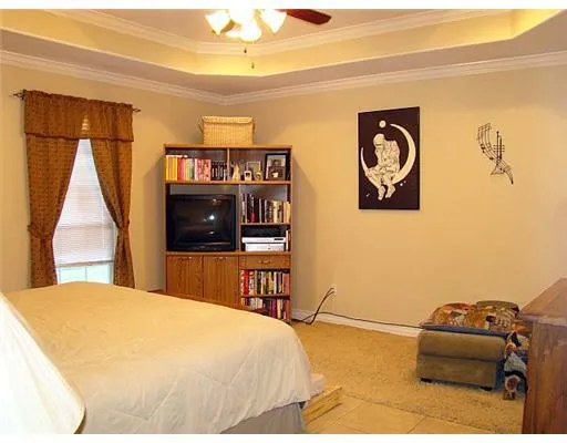 a bedroom with a bed and a television