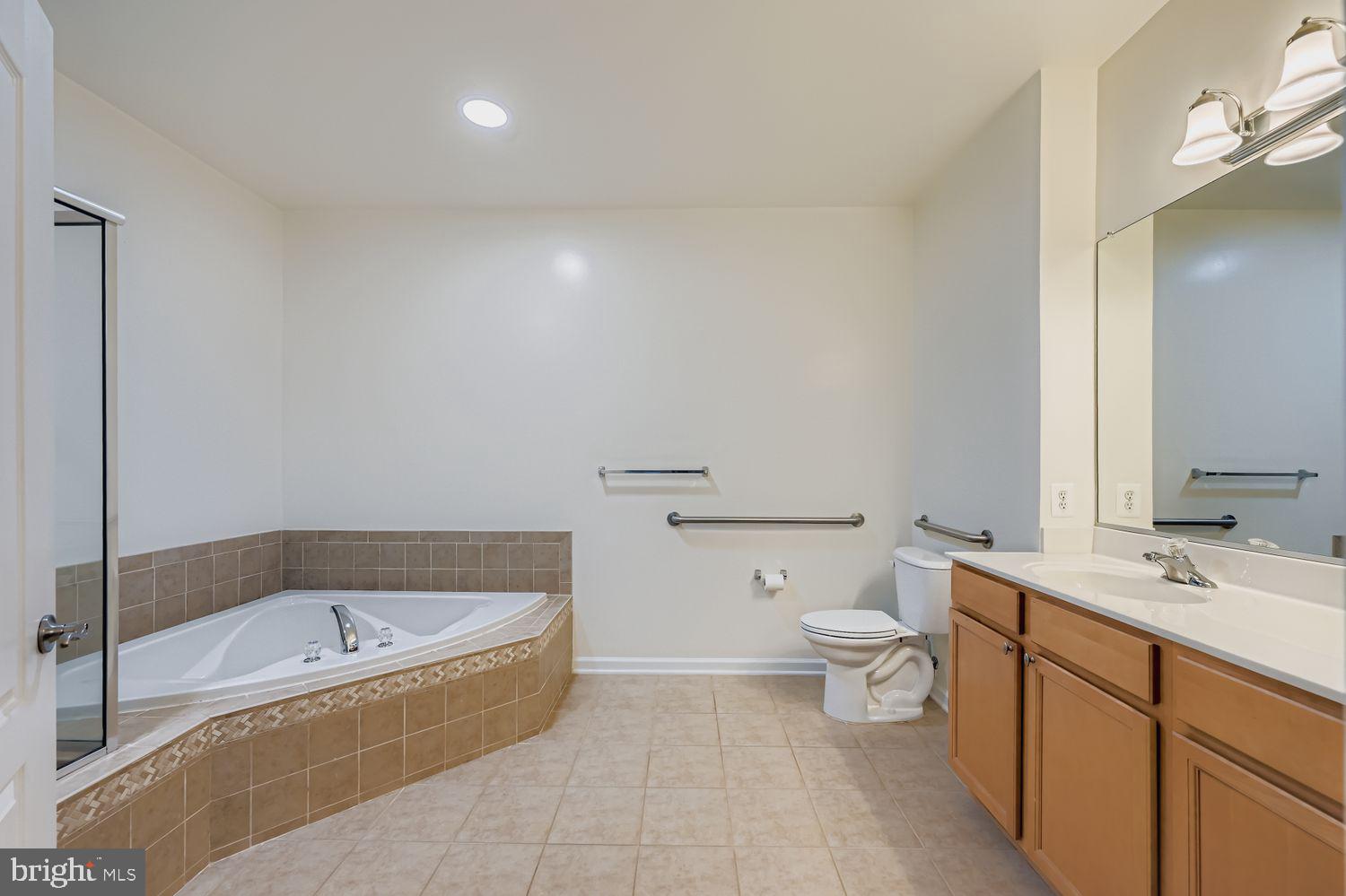 1412 Wigeon Way, Unit 101 Gambrills, MD 21054 - Photo 10 of 18 Primary Bath with Double Sinks and Soaking Tub