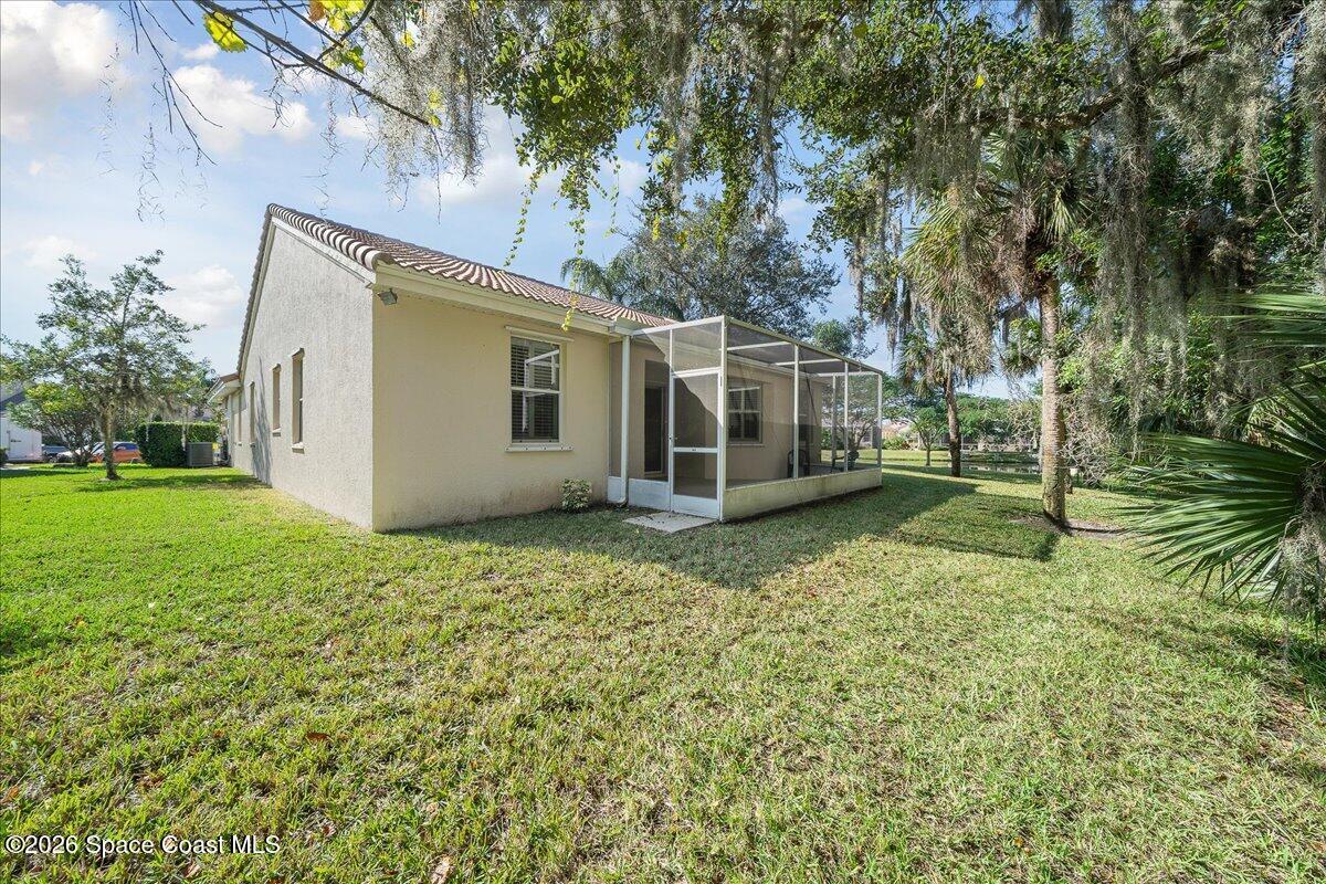 8200 Simpkins Way Melbourne, FL 32940 - Photo 20 of 49 a view of a house with a backyard