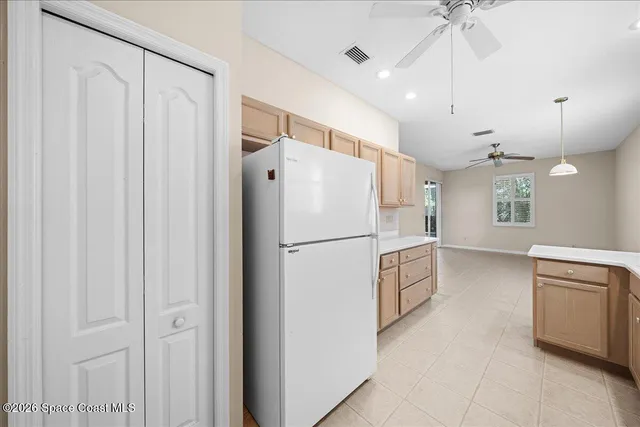 a white refrigerator freezer sitting inside of a kitchen