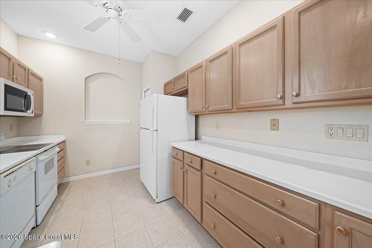 8200 Simpkins Way Melbourne, FL 32940 - Photo 33 of 49 a kitchen with cabinets appliances and a counter space