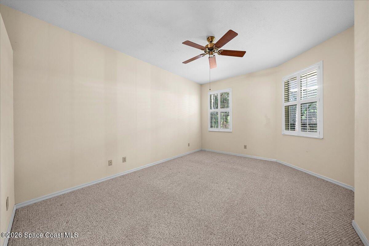 8200 Simpkins Way Melbourne, FL 32940 - Photo 34 of 49 an empty room with windows and fan