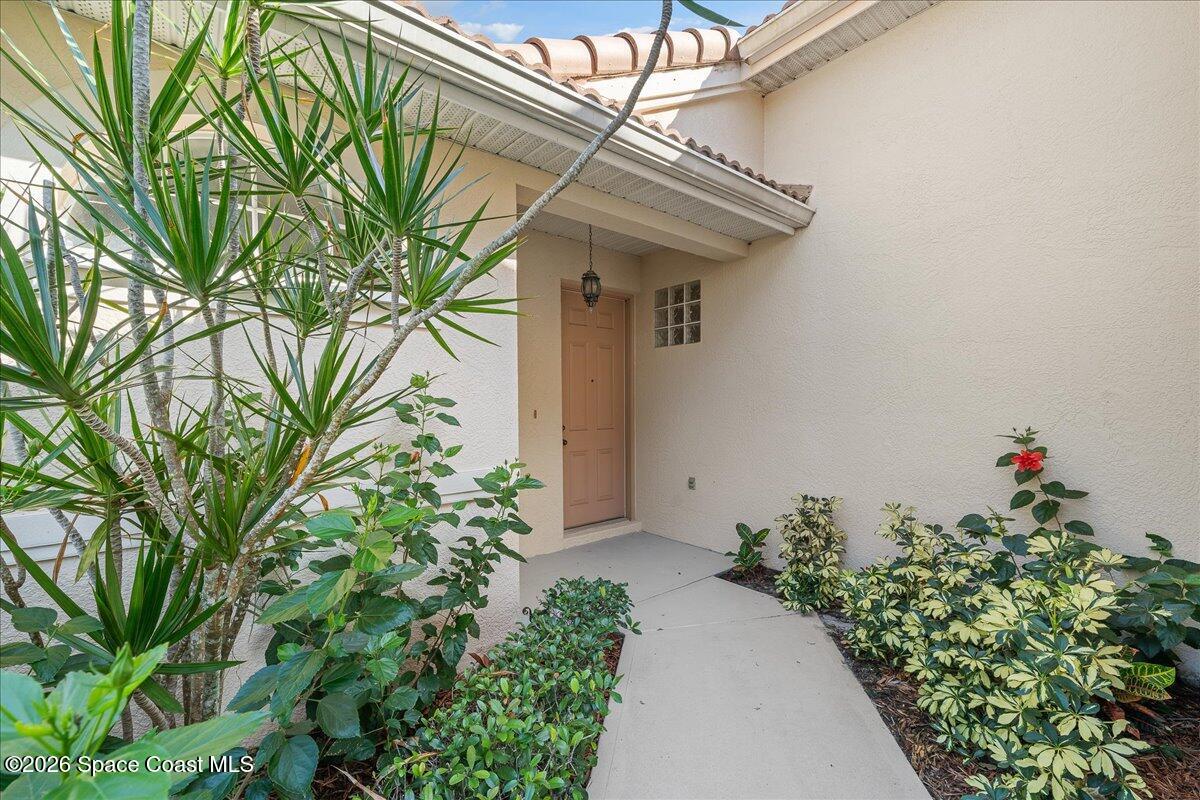 8200 Simpkins Way Melbourne, FL 32940 - Photo 4 of 49 a flower plants in front of a house