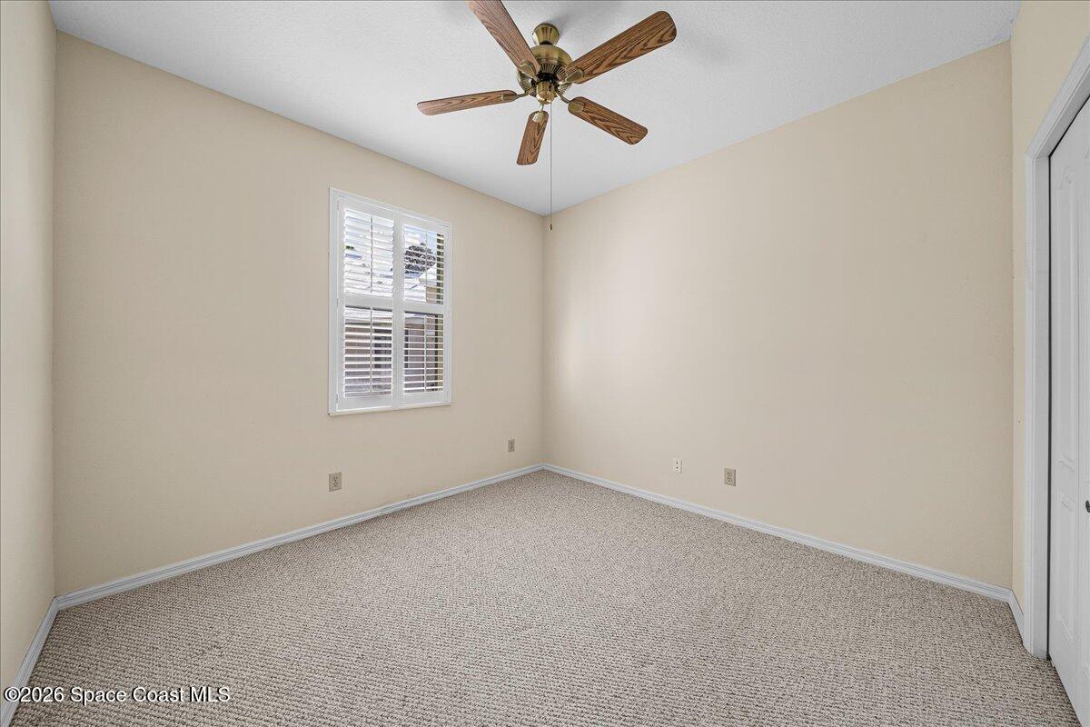 8200 Simpkins Way Melbourne, FL 32940 - Photo 42 of 49 an empty room with a window and a fan