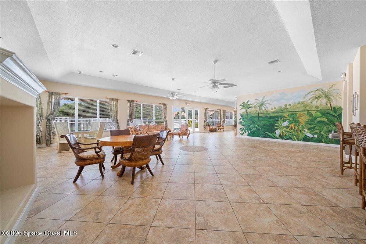8200 Simpkins Way Melbourne, FL 32940 - Photo 48 of 49 a dining room with furniture and a floor to ceiling window