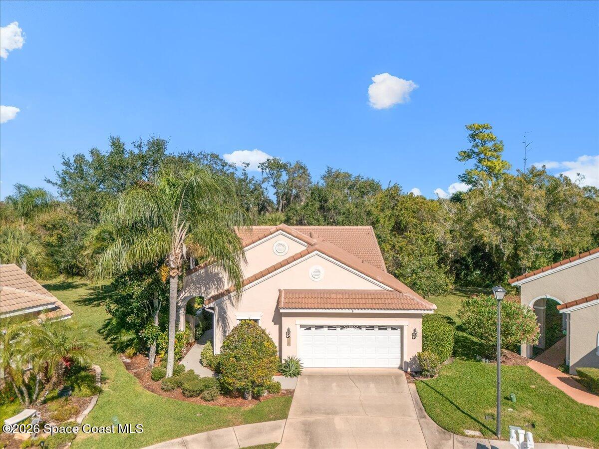 8200 Simpkins Way Melbourne, FL 32940 - Photo 8 of 49 a view of a white house with a yard and potted plants