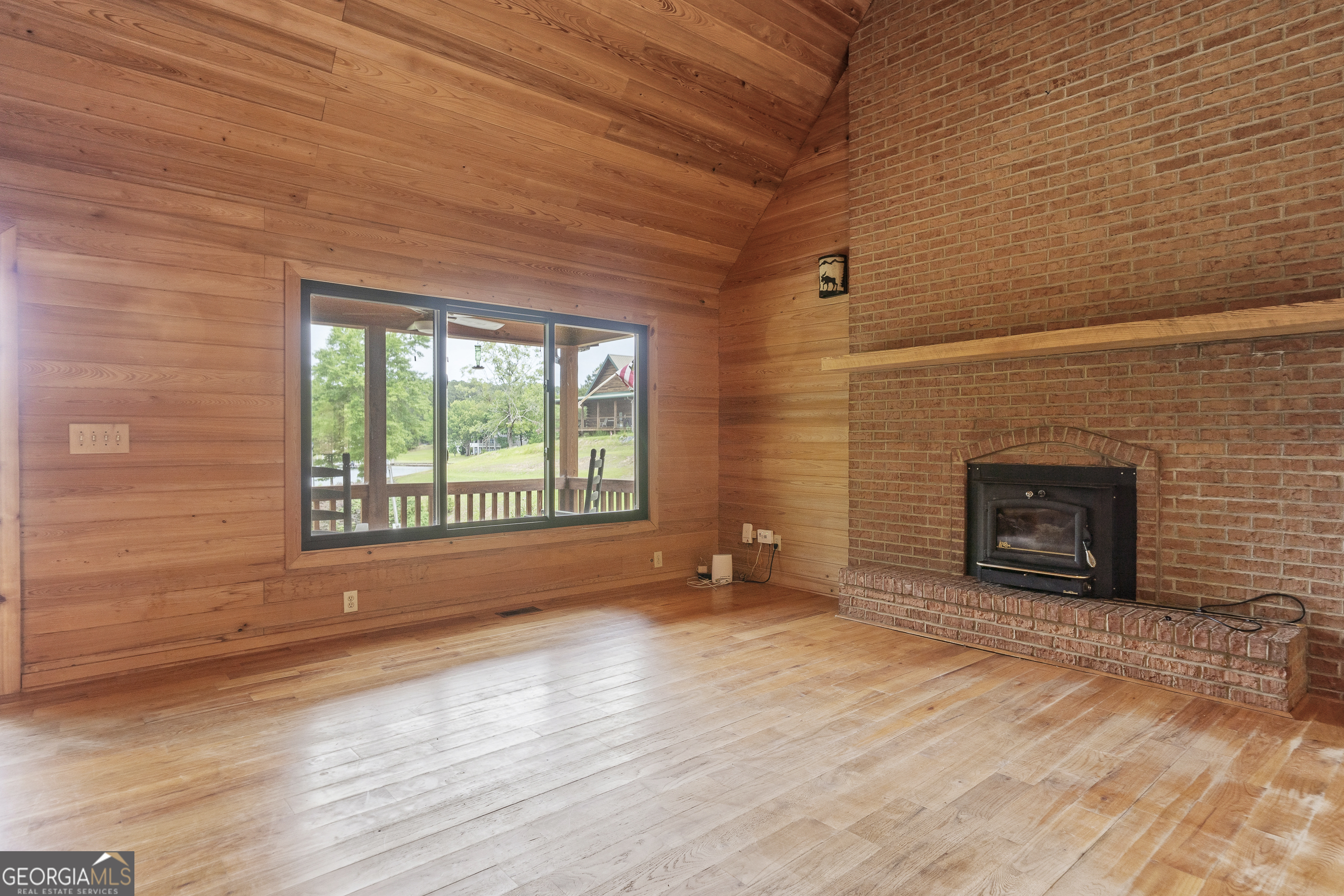 63 Tomahawk Drive Sparta, GA 31087 - Photo 15 of 60 a view of an empty room with a fireplace and a window