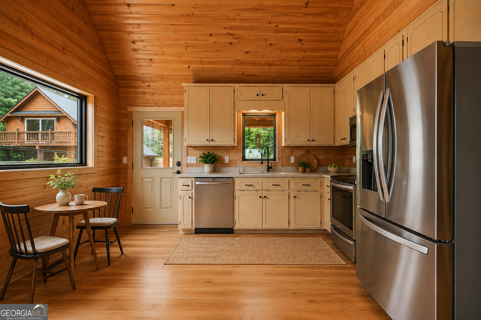 63 Tomahawk Drive Sparta, GA 31087 - Photo 17 of 60 a kitchen with a refrigerator a sink and chairs