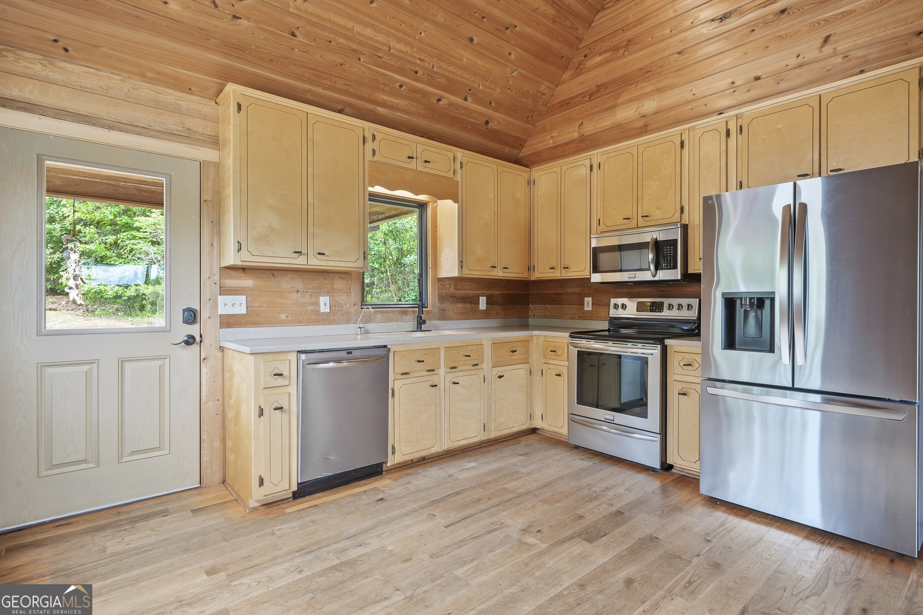 63 Tomahawk Drive Sparta, GA 31087 - Photo 20 of 60 a kitchen with a refrigerator stove a sink and dishwasher with wooden floor