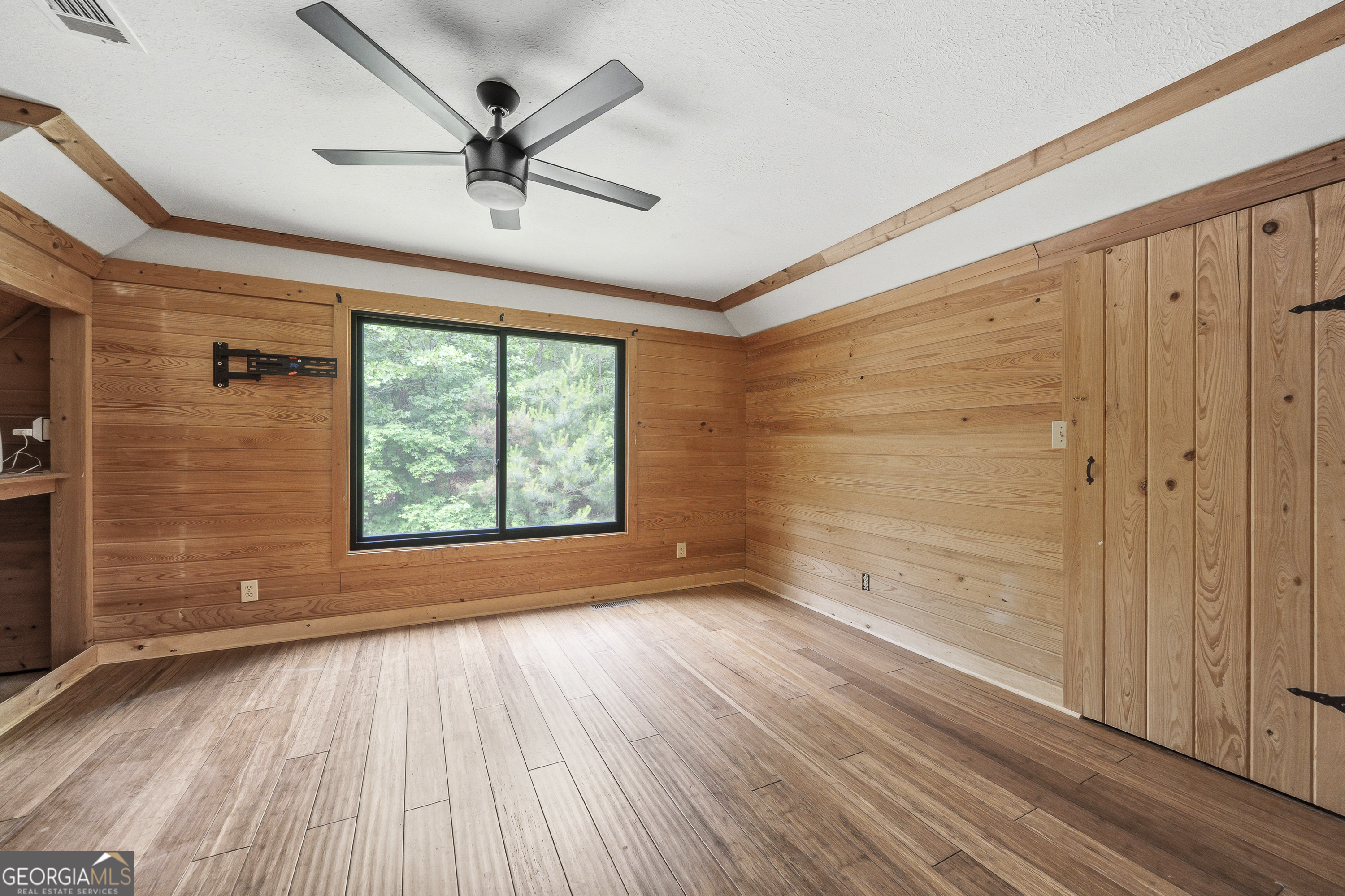 63 Tomahawk Drive Sparta, GA 31087 - Photo 30 of 60 a view of empty room with wooden floor and fan