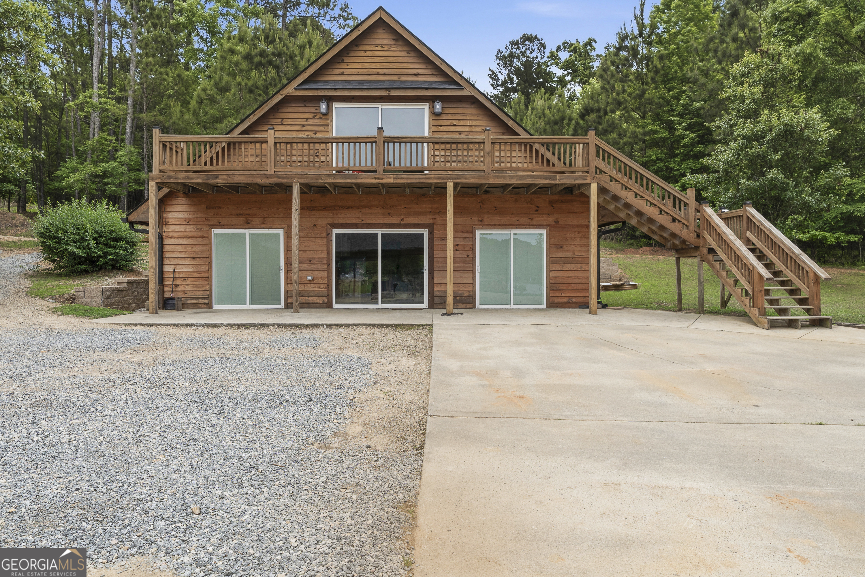 63 Tomahawk Drive Sparta, GA 31087 - Photo 50 of 60 a front view of a house with a yard and garage