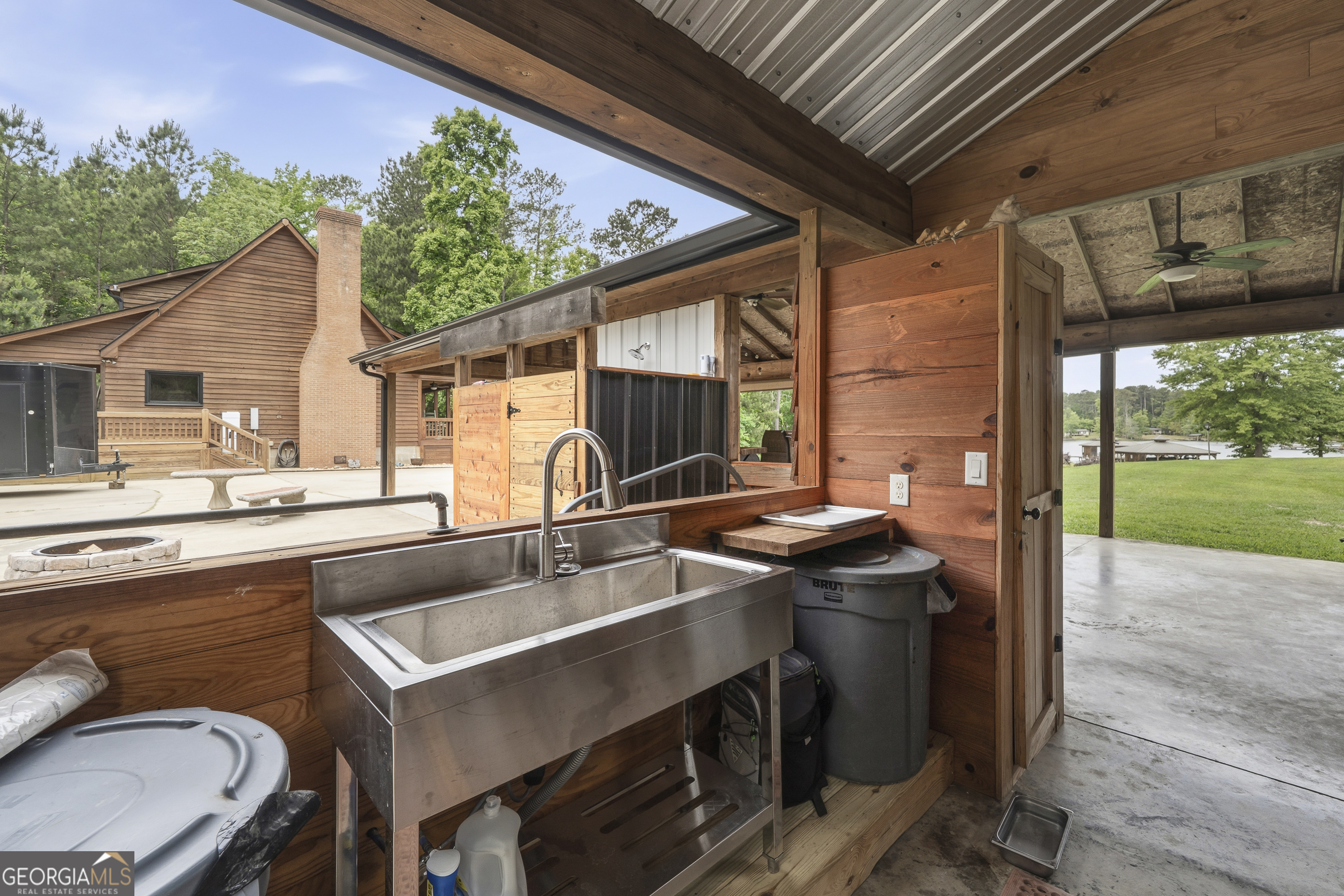 63 Tomahawk Drive Sparta, GA 31087 - Photo 57 of 60 a view of a patio with table and chairs a barbeque with wooden floor and fence