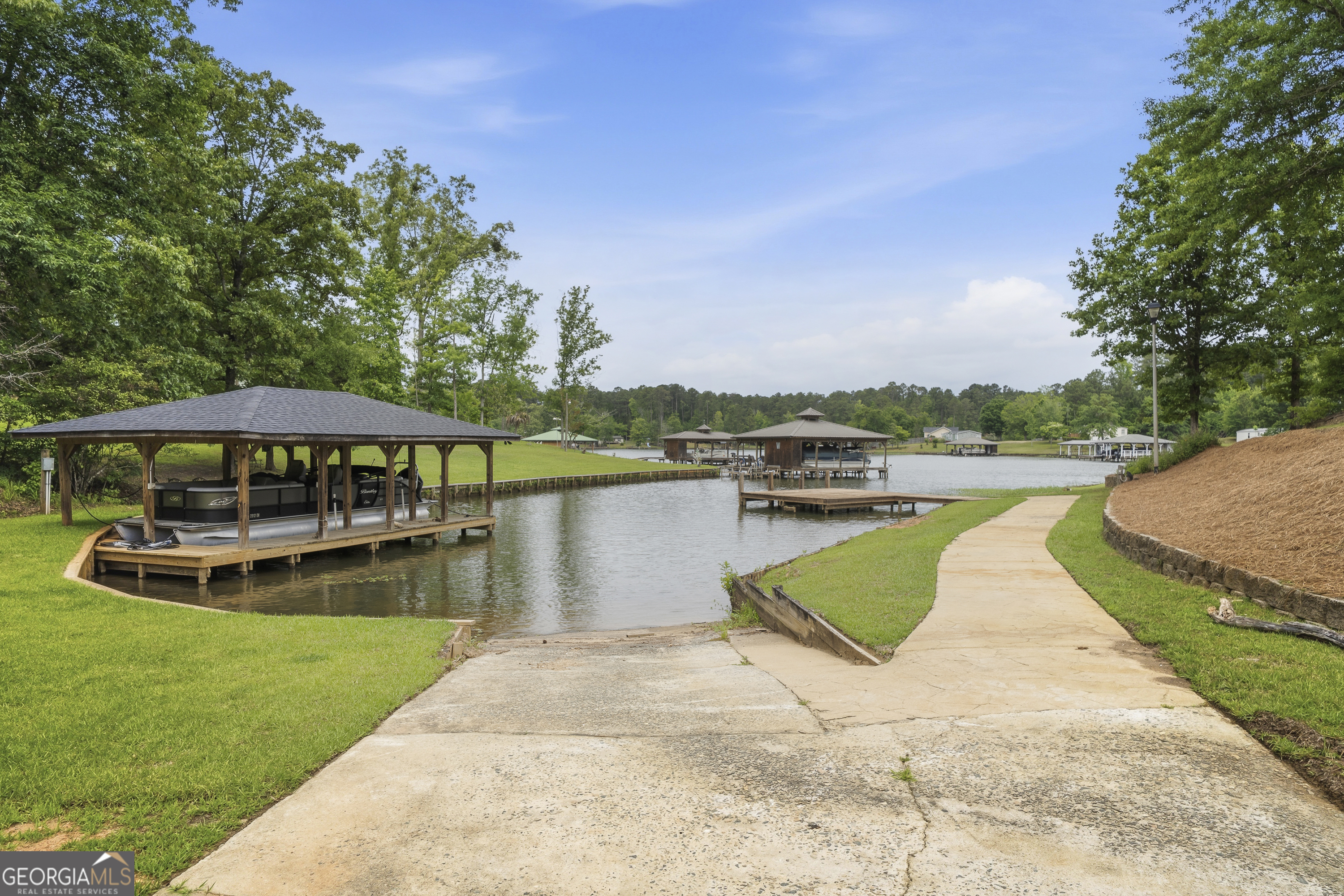 63 Tomahawk Drive Sparta, GA 31087 - Photo 59 of 60 a view of a lake with a yard and a large tree