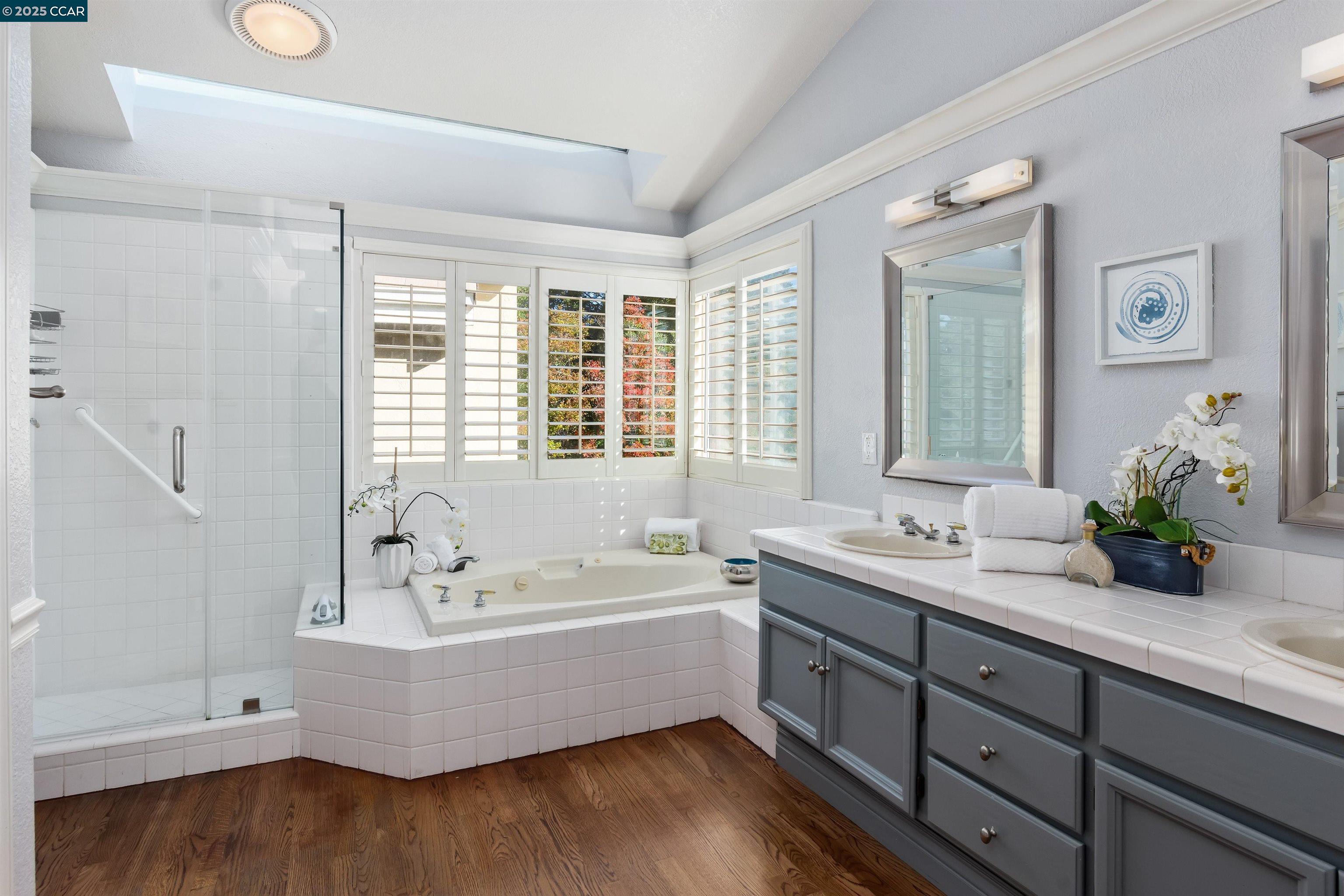 226 Lakeridge Way San Ramon, CA 94582 - Photo 31 of 59 a bathroom with a tub double vanity sink and mirror