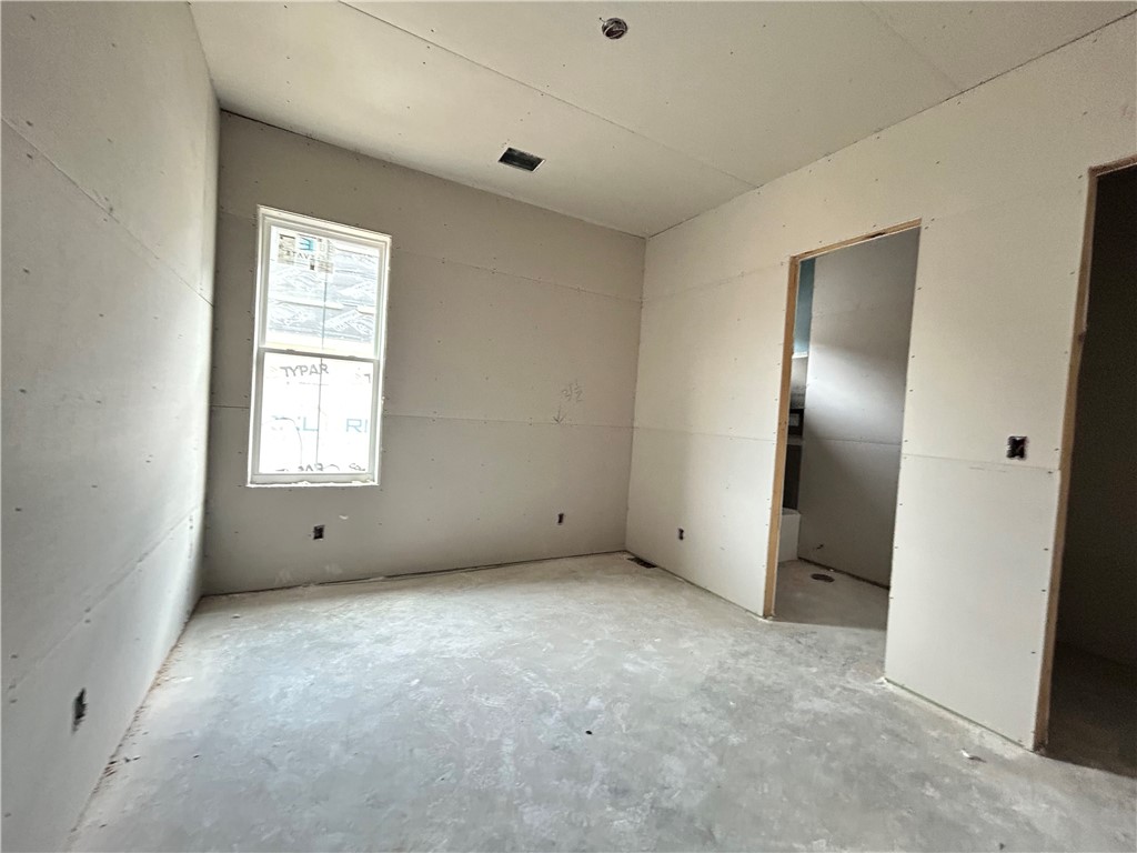 7028 Skipping Rock Path Bryan, TX 77808 - Photo 11 of 18 an empty room with windows and closet