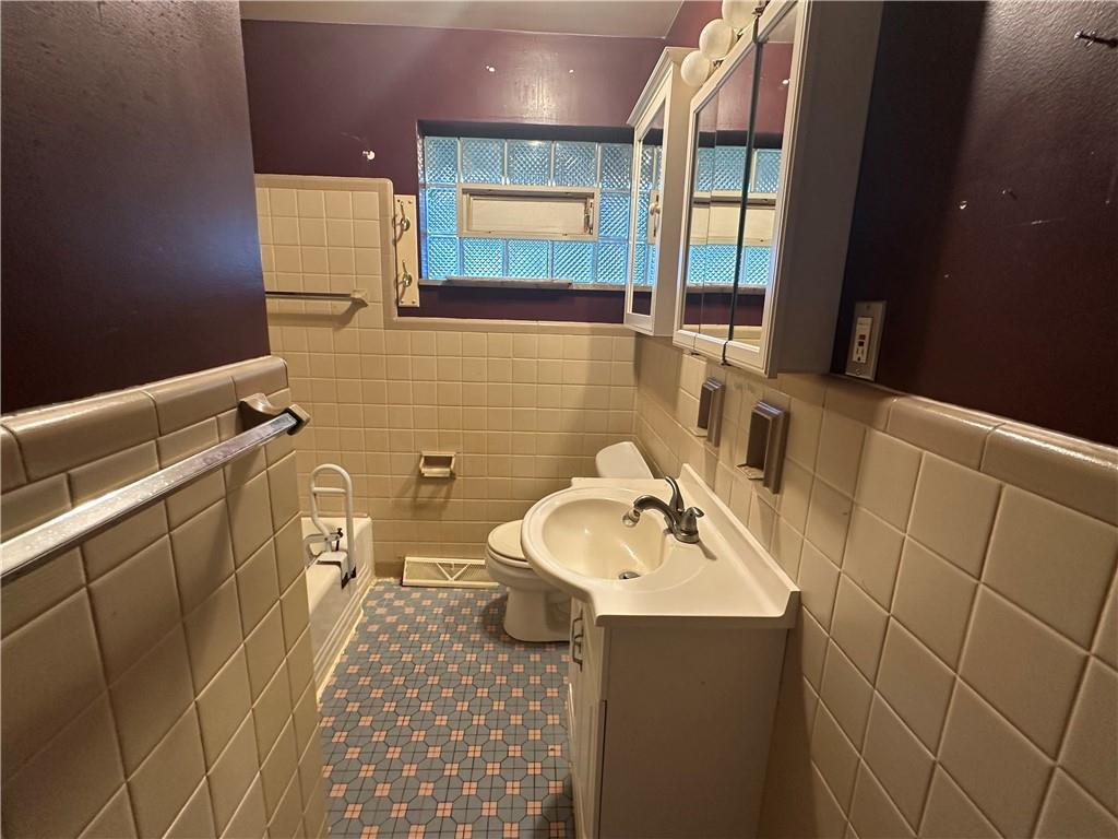 407 Evans City Road Butler, PA 16001 - Photo 8 of 13 a bathroom with a sink a toilet and mirror