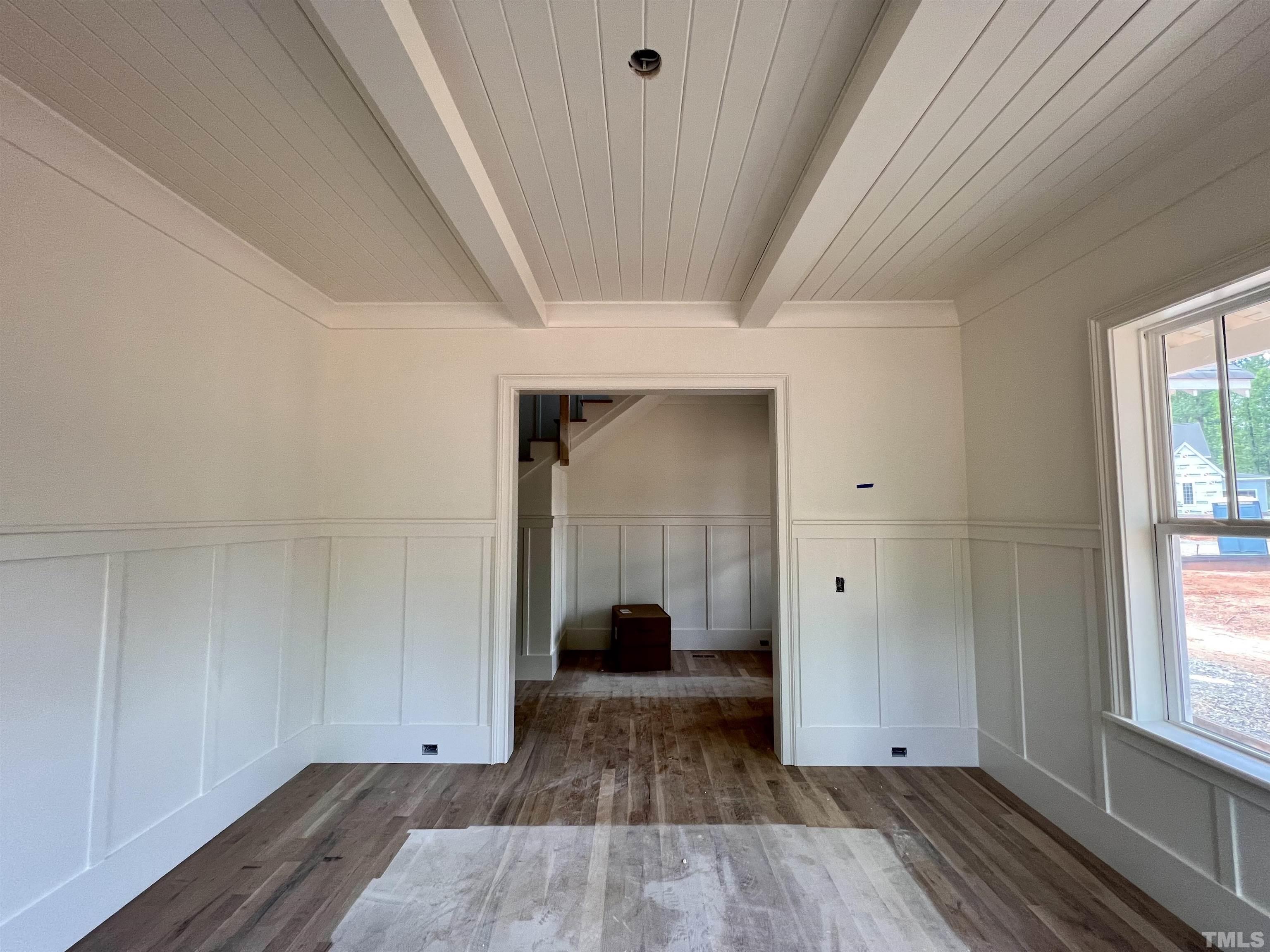 7208 Sing Along Court Raleigh, NC 27613 - Photo 4 of 47 a view of empty room with wooden floor and fan