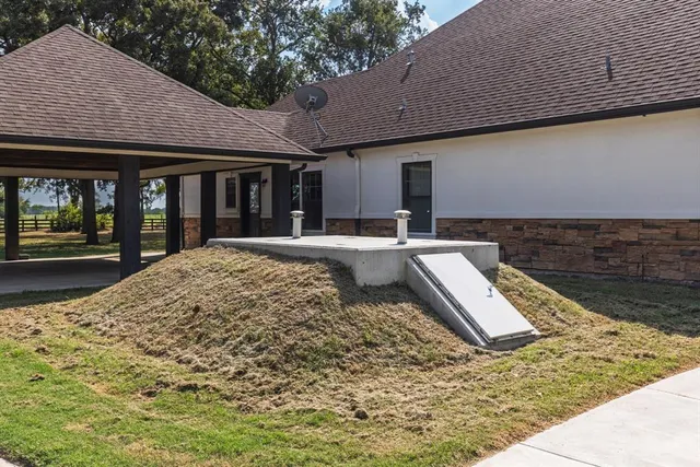 a view of a house with wooden floor and roof with a sitting space