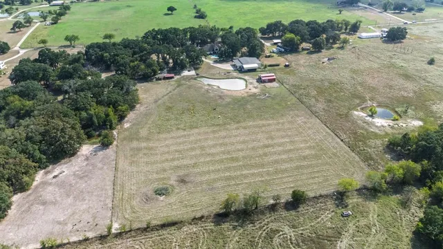 a view of a swimming pool with an outdoor seating and a yard