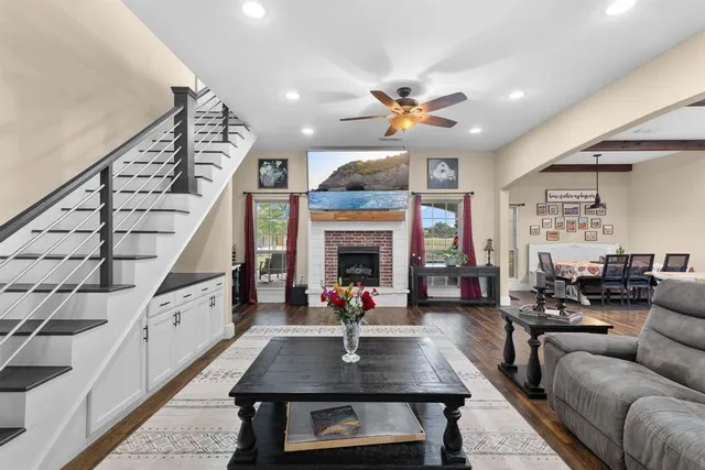 a living room with furniture a fireplace and a chandelier