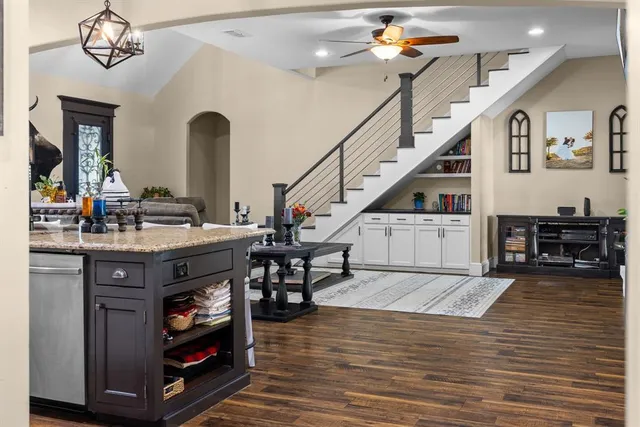a living room with furniture and a dining table
