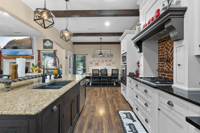 a kitchen with sink stove and cabinets
