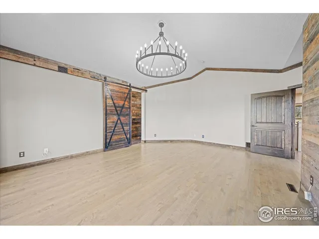 a view of an empty room with a fireplace and a window