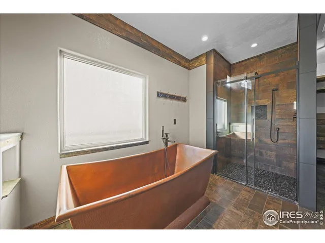 a bathroom with a bathtub and a shower