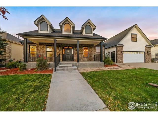 a front view of a house with garden and porch