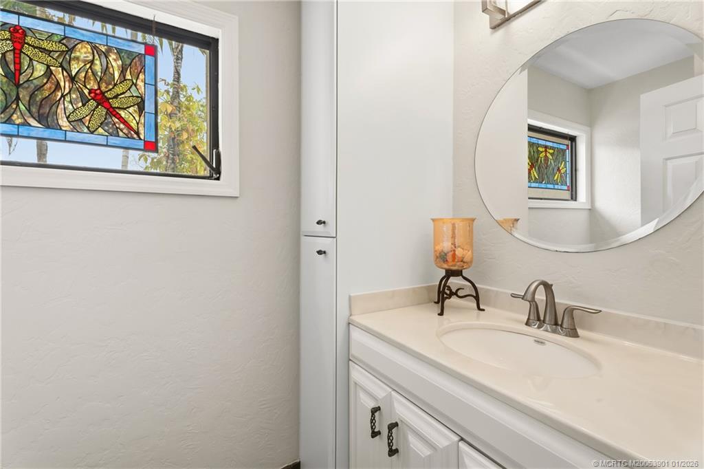 4761 Southeast Binnacle Way, Unit 108 Stuart, FL 34997 - Photo 12 of 25 a bathroom with a sink and a mirror