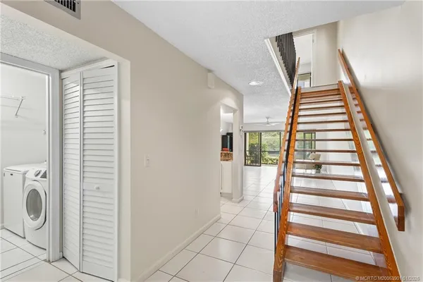a view of entryway with stairs and wooden floor