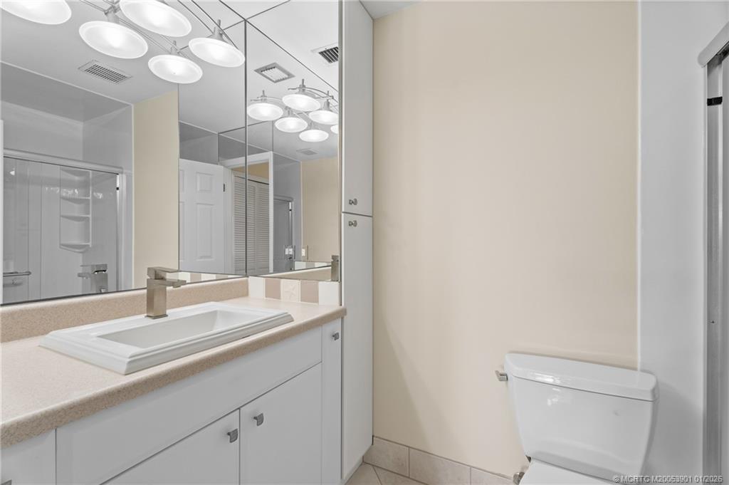 4761 Southeast Binnacle Way, Unit 108 Stuart, FL 34997 - Photo 16 of 25 a bathroom with a sink and a mirror